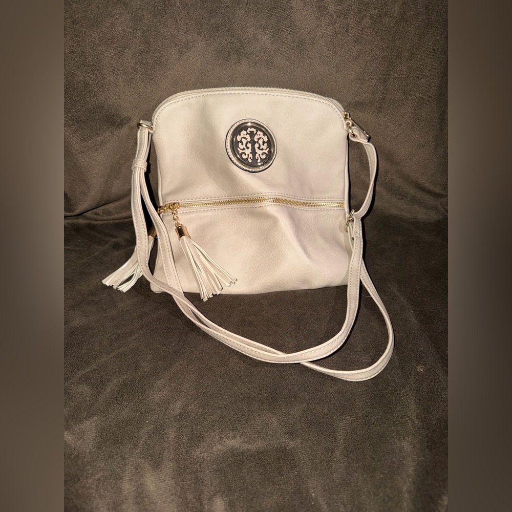 Cream Crossbody Bag with Tassel and Medallion Detail